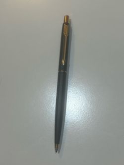 show a Parker Classic Matte Black and Gold Trim Ballpoint Pen, which is a slim, twist- or push-action luxury writing instrument featuring a matte blac