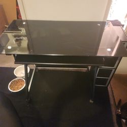 Black glass desk with black chair
