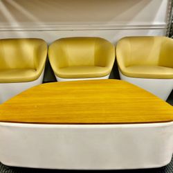 Set of mid-century modern lounge chairs and a coffee table. 