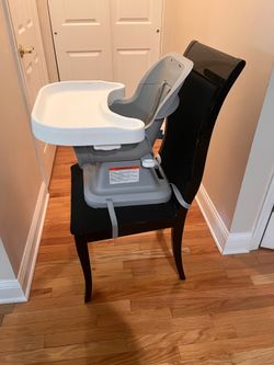Portable booster seat with tray, easy to attach to chairs $25 cash only. Cross Posted