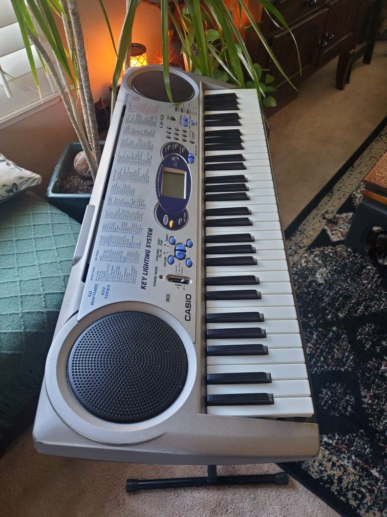 Casio Keyboard With Stand And Chair .Works Great And Lights Up.