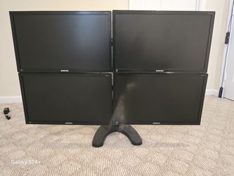 Four Samsung Monitors On A Swivel Ready To Connect