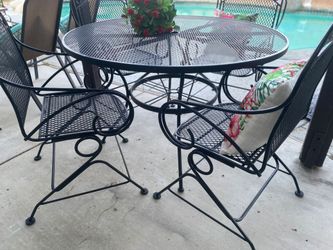 Heavy wrought iron four rocking chairs with table size 48 inches diameter