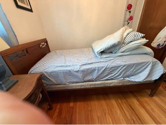 Twin bed with side table and chest