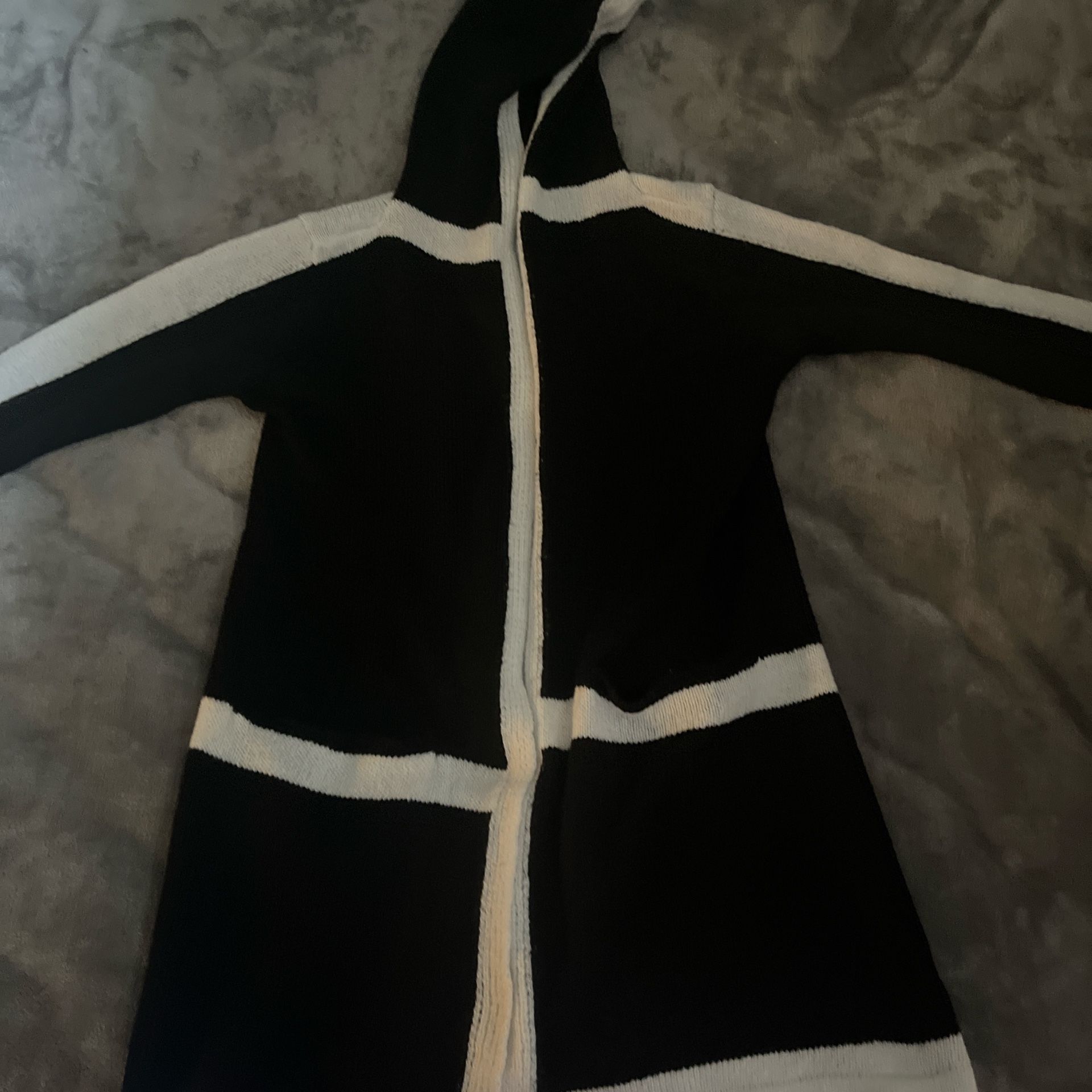 Warm, thick, and stylish—this long black and white cardigan is cozy, cute, and perfect for layering.