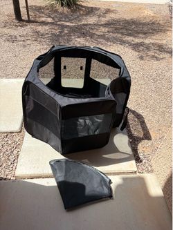 portable black pet playpen with mesh windows and a zippered entrance
