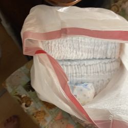 trash bag full of size one diapers 