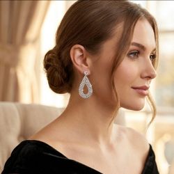Women’s silver toned teardrop/dangle earrings. Clustered with rhinestones