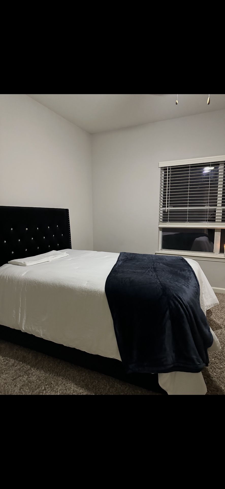 Full sized bed with frame and mattress.