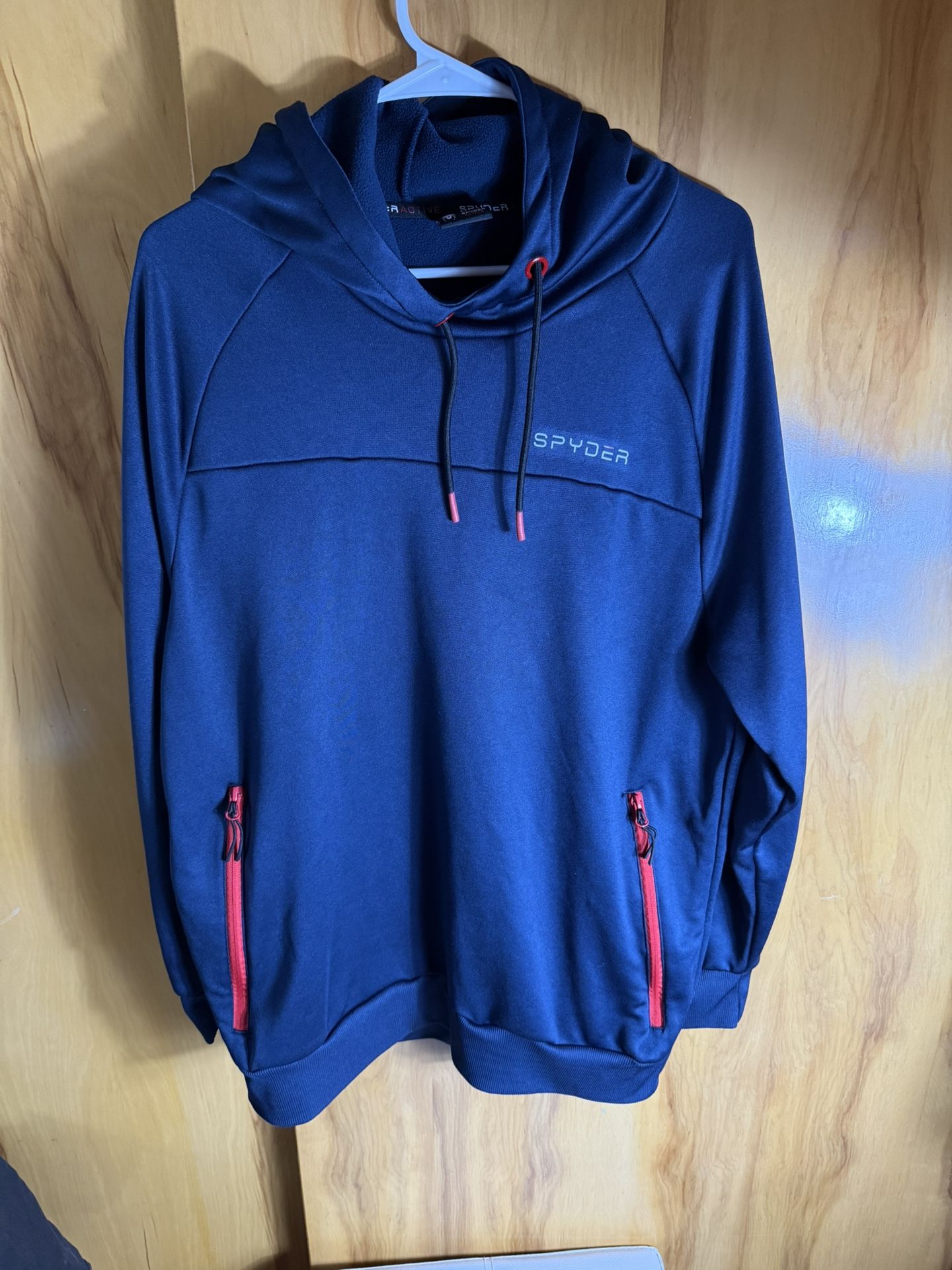 Spyder men's active Proweb stretch pullover hoodie in blue with red zipper accents