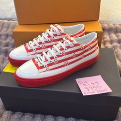 Chic Louis Vuitton sneakers with red and white stripes. Features signature monogram design. Ideal for everyday style.