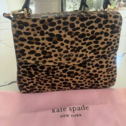 Kate Spade New York Leopard Print Top Handle Bag  Elegant Kate Spade top handle bag featuring a bold leopard print design. Chic, stylish, and perfect 
