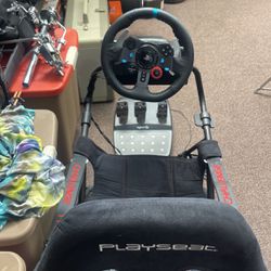 Racing Simulator Seat, Along With Steering Wheel And Gas And BrakePedals
