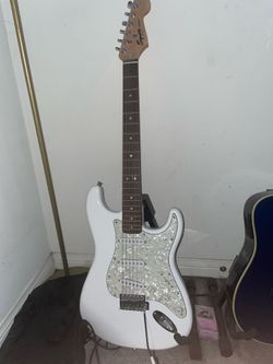 Squier Strat electric guitar in good working condition.