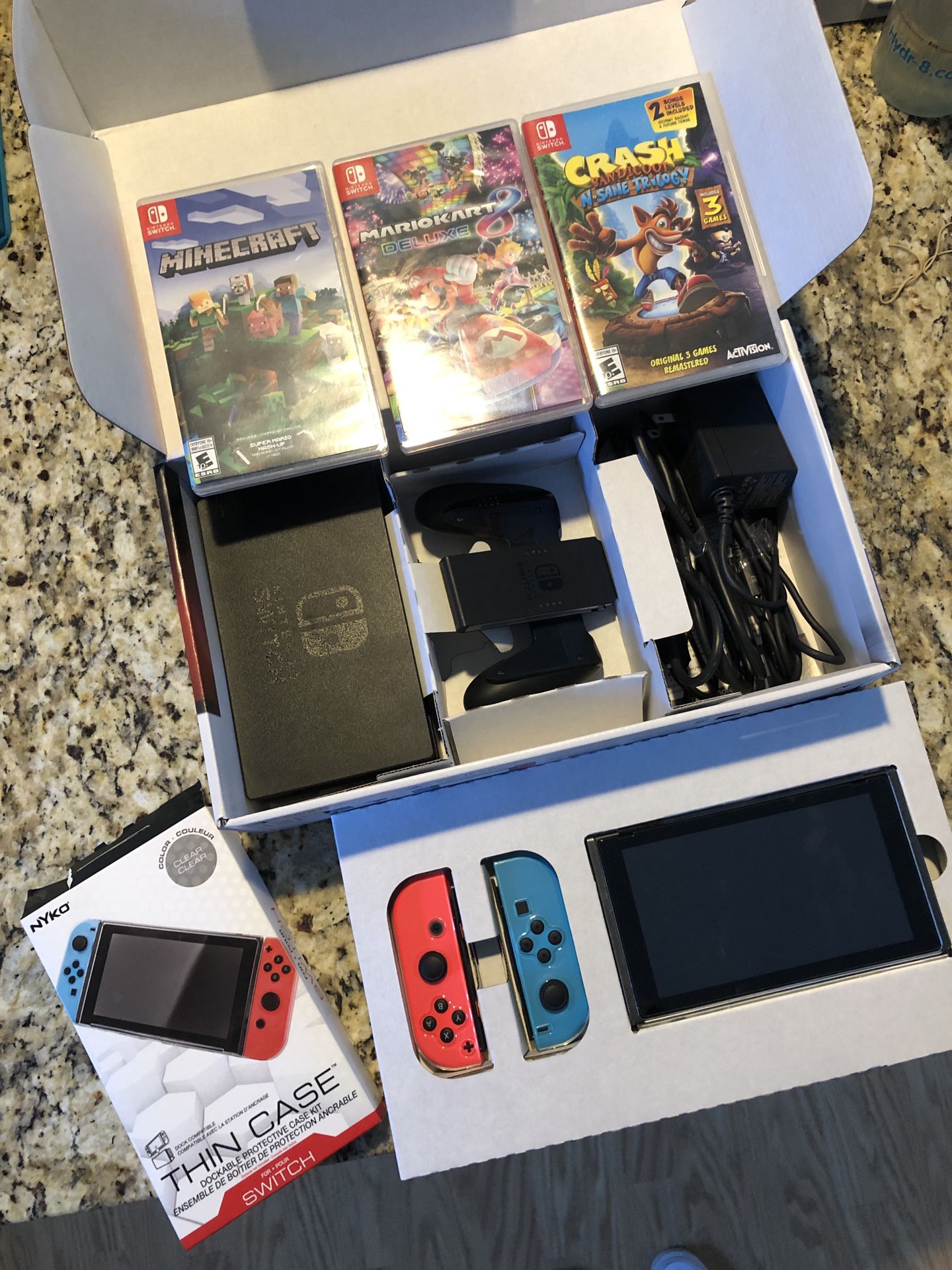 Nintendo switch with case, extra screen protector and three games.