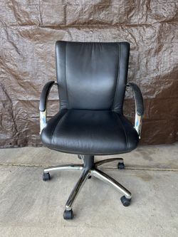 Black and chrome desk chair on wheels