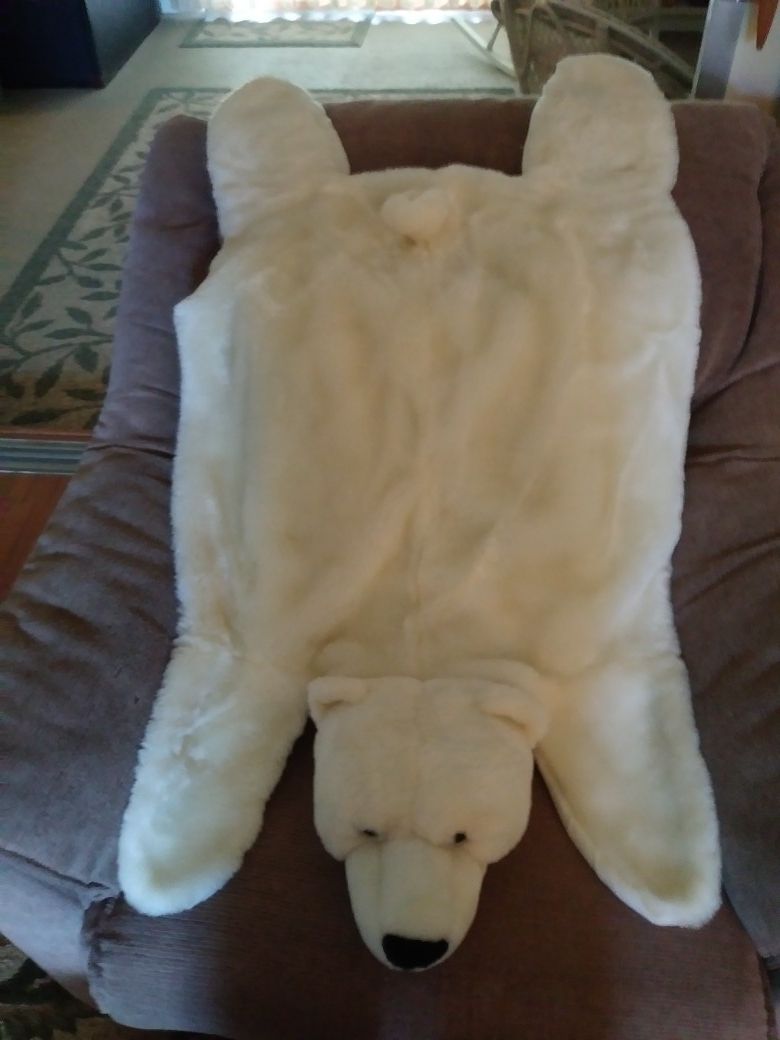 Stuffed polar bear fpr the floor resembles skinned bear on floor but for kids