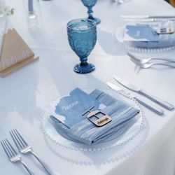 Dusty blue napkins And Clear Chargers
