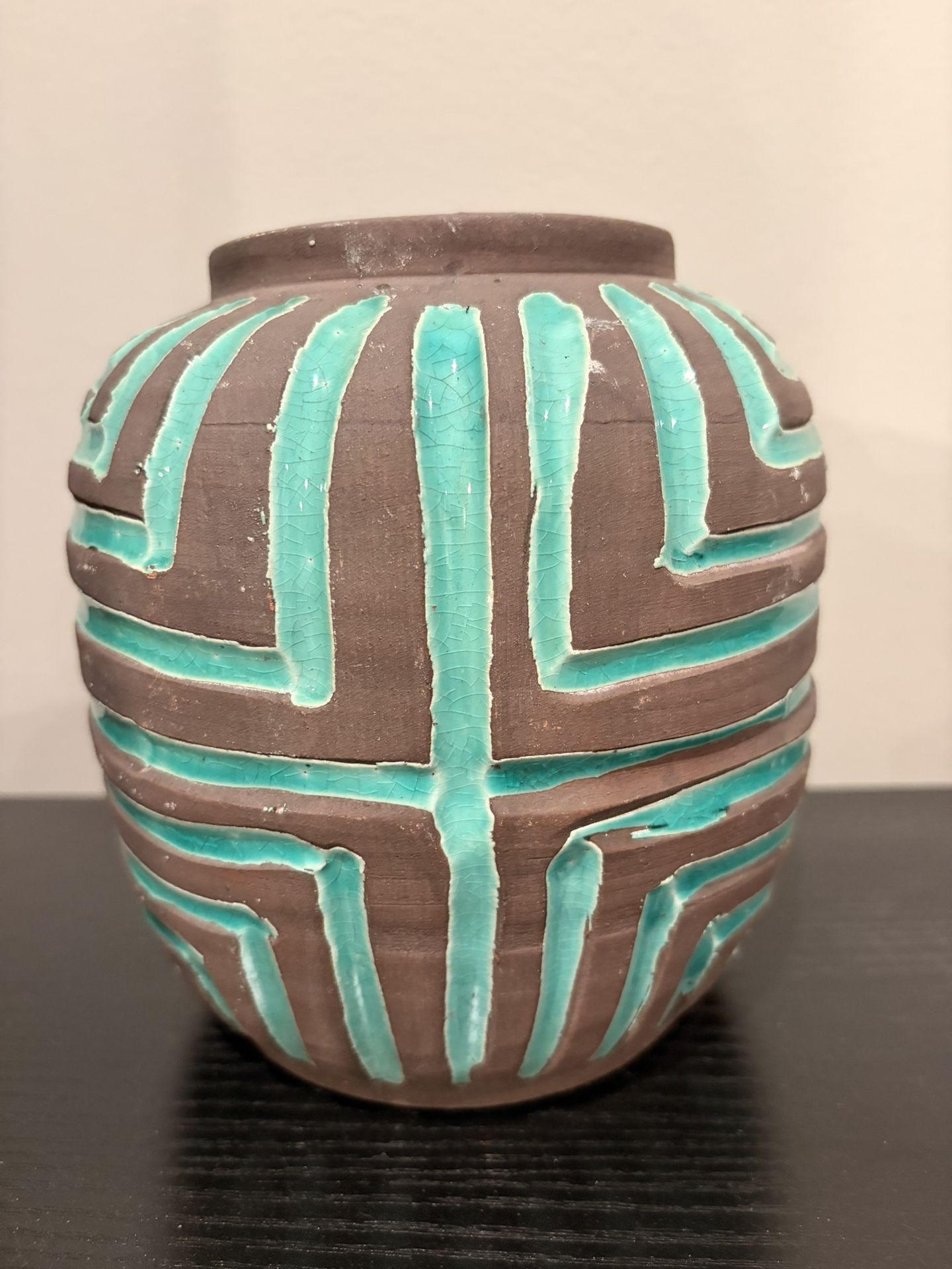 One of a kind vase in brown accented with teal. 7” tall 3 1/4” opening