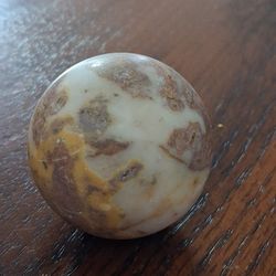 Polished sphere made of natural stone, likely a type of marble