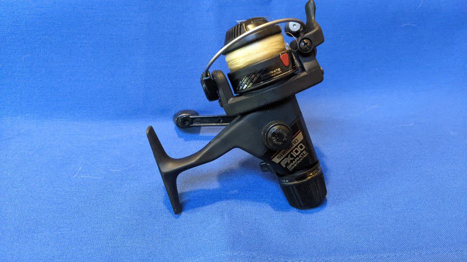 Shimano FX-100 Graphite Quick fire 2. Used But In Great Shape All Around.  This Reel Is Known For Its Reliability And Functioning In Adverse Weather.