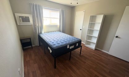 Full size mattress with black metal frame.