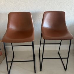 Two whiskey brown stools