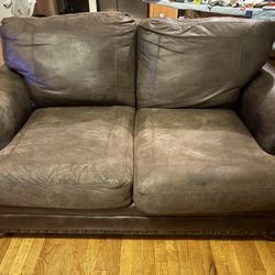 Brown leather loveseat
