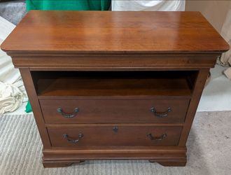 Broyhill furniture brand media chest features a rich mahogany finish.