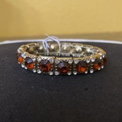 A  Gold Color With Brown Stones 