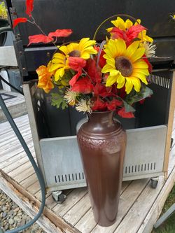 Tall vase with artificial flowers