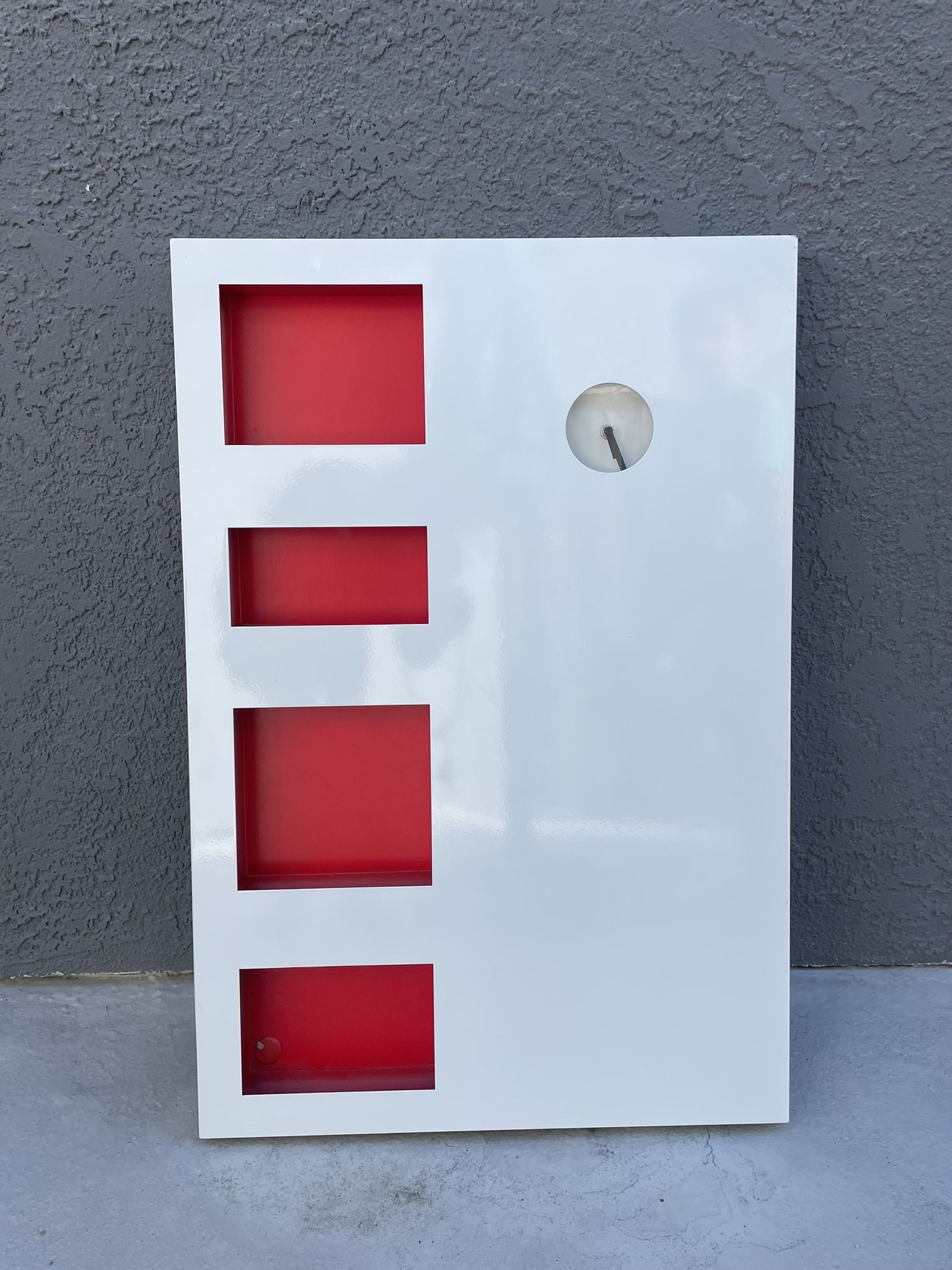 IKEA 'Jagga' Dry Erase Magnetic Whiteboard. Wall mounted with 4 red shelf inserts (ex. for mail). Clock does not work. Measures 21.75" by 32.25"