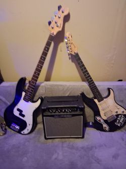A Yamaha guitar and a Fender bass with amp ang case