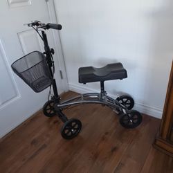 KNEE WALKER/SCOOTER:  ADJUSTABLE, FOLDABLE, DUAL HAND BRAKES, BASKET. CHARCOAL FRAME. EXCELLENT CONDITION!