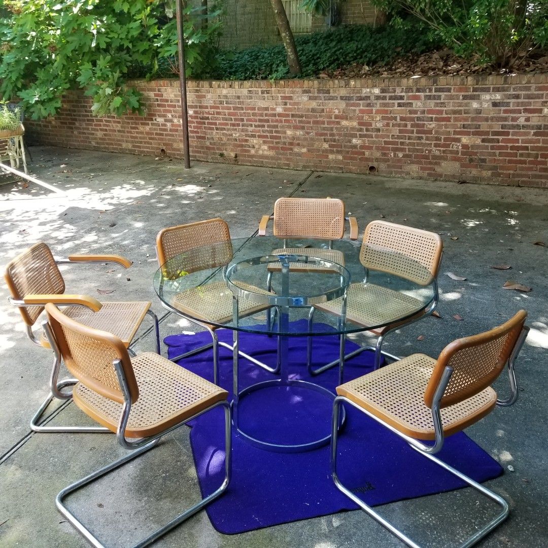 Glass table with chrome base with 6 chairs.