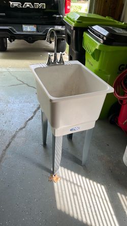 Mustee 12C Utilatub combo laundry tub, featuring a white polypropylene basin and heavy-gauge steel legs.