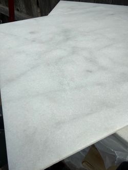 White marble tiles, great for backsplashes or decorative accents.