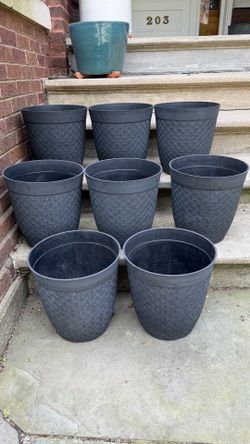 8 identical dark gray plastic planters