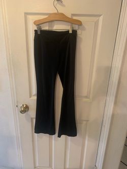 Beautiful girls’ black party dress with gold sequin details on the front, a black satin bow at the waist, and a layered tulle skirt. Sleeveless design