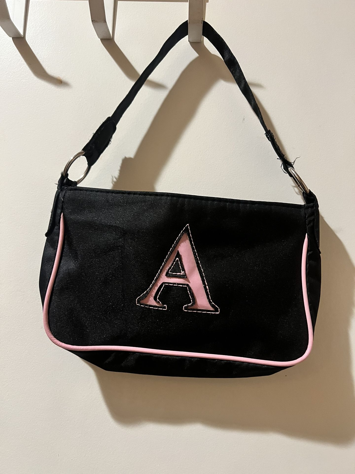 Stylish black and pink small bag with a bold 'A' design. Perfect for purse or makeup bag. New no tags W9xH6 inches