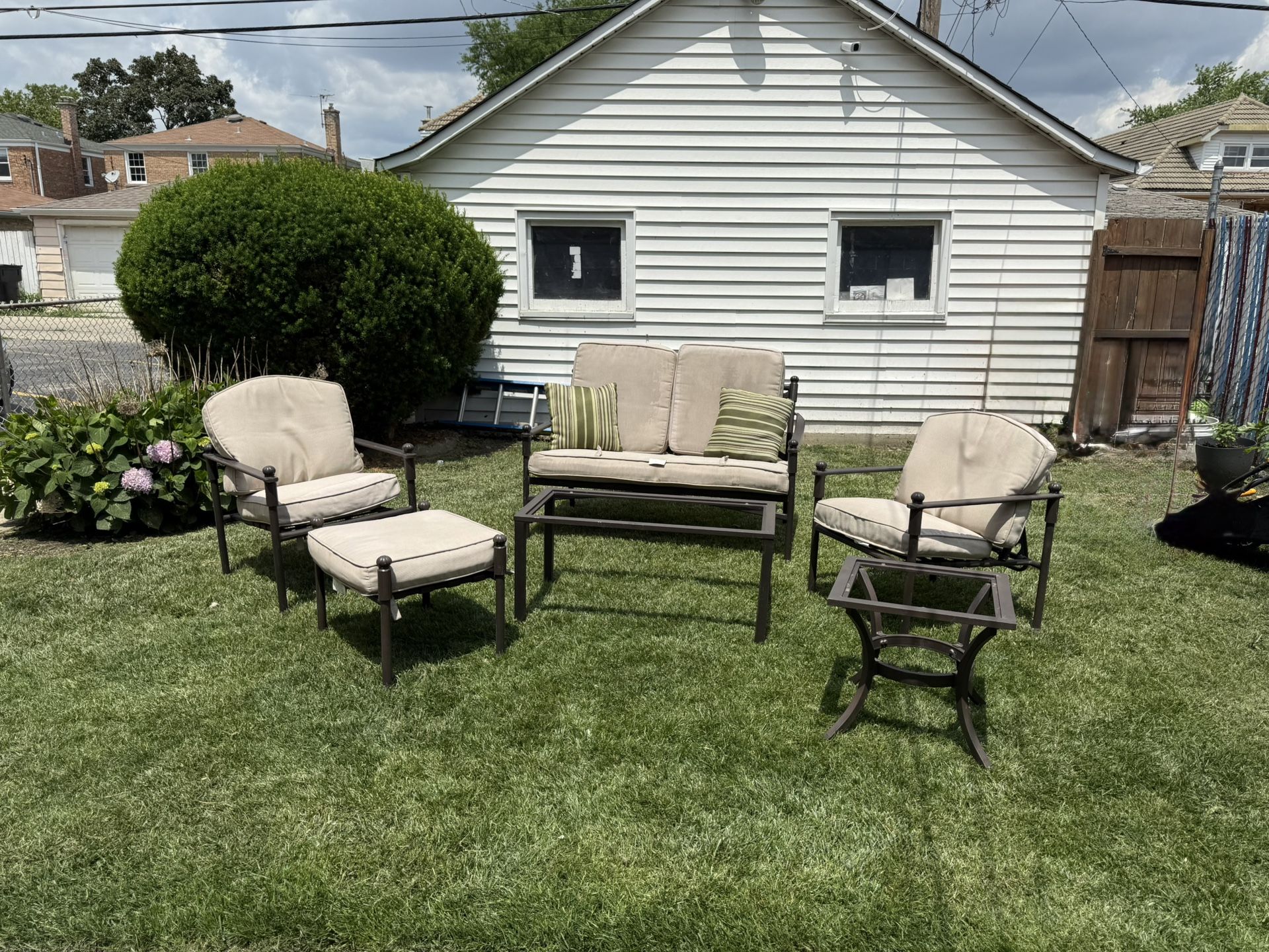 BEAUTIFUL AND COMFORTABLE PATIO SET. IT INCLUDES 1 BENCH,2 RECLINING CHAIRS,1 OTTOMAN AND 2 GLASS TOP TABLES. $250.00 OR BEST OFFER.
