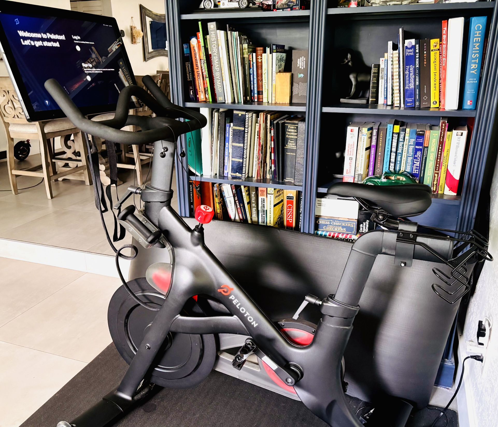 Peloton Bike – Like New! Only 11 Hrs + Mat, Weights & Shoes