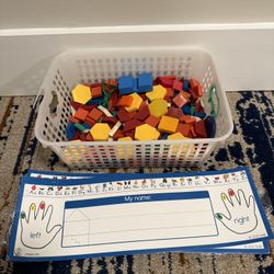 Basket of geometric shapes and name tags with letters 