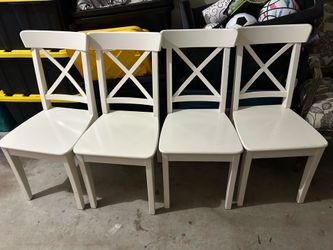4 identical wooden chairs