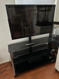 Modern black glass TV stand with LG TV
