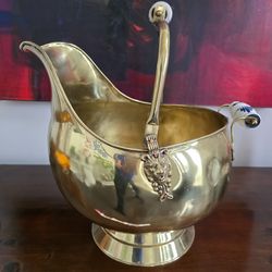 Brass coal scuttle with Delft porcelain handles and lion head decorations