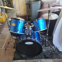 Complete  5 Pc  Mendini Drum Set in a Metallic Blue Plastic Wrap Complete with  Bass Pedal, Cymbals, Hardware  and Seat = $175