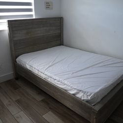 Rustic wood bed frame with clean mattress included