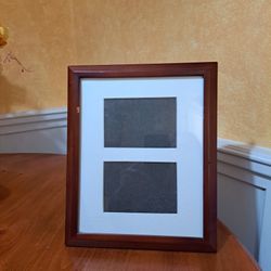 Brown picture frame 9 1/2 in by 11 1/2 in. Holds two 4 by 6 pictures.