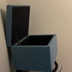 large, light blue, upholstered storage ottoman 